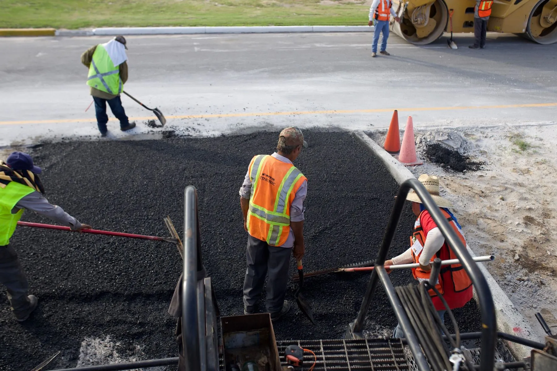 Asphalt paving crew placing fresh asphalt